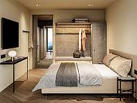 Modern eingerichtetes Schlafzimmer mit Bett, Kleiderschrank, Wandregal und kleinem Tisch.