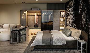 Modern eingerichtetes Schlafzimmer mit Bett, Ankleidebereich, Sofa und warmen Holztönen.